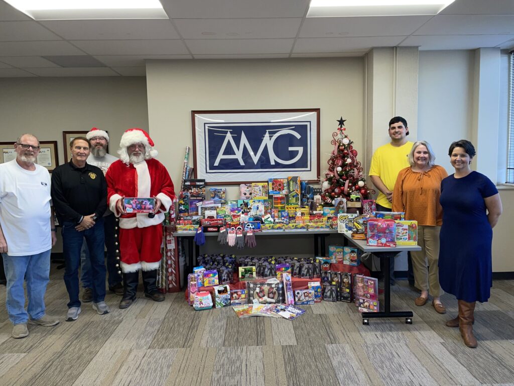AMG V staff in front of collected food for donation
