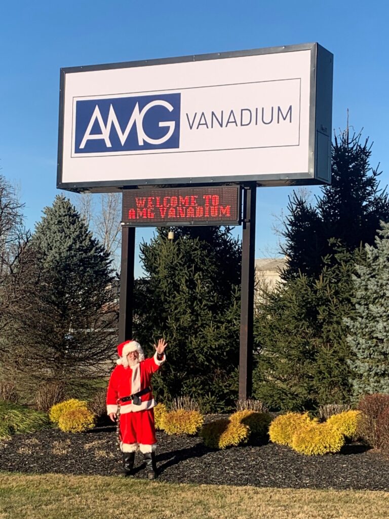 AMG-Vanadium-Cambridge-Toy-Drive-for-Secret-Santa-Pic-of-Santa-in-front-of-AMG-Sign