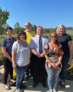 Shown are, from left, Kayla Helser with AMG, Alissa Kovach, president of Feed My People, James Johnson with GMA, Captain Ed McMillen of The Salvation Army, Shannon Shatto, director of G.R.A.C.E. Pantry, and Colleen Heacock with AMG.
